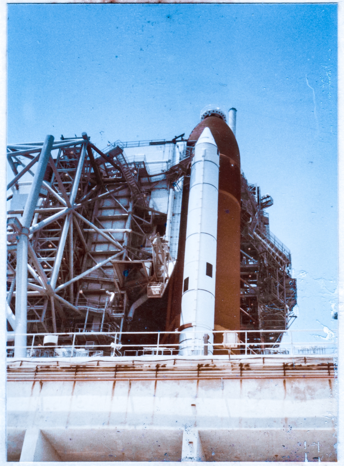 August 10, 1984, Space Shuttle Discovery, initial rollout to Launch Complex 39-A, Kennedy Space Center, Florida, prior to its first launch, viewed from the access road leading to the high-pressure gas facility on the east side of the pad.